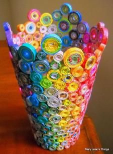 a vase filled with lots of colorful rolled up paper