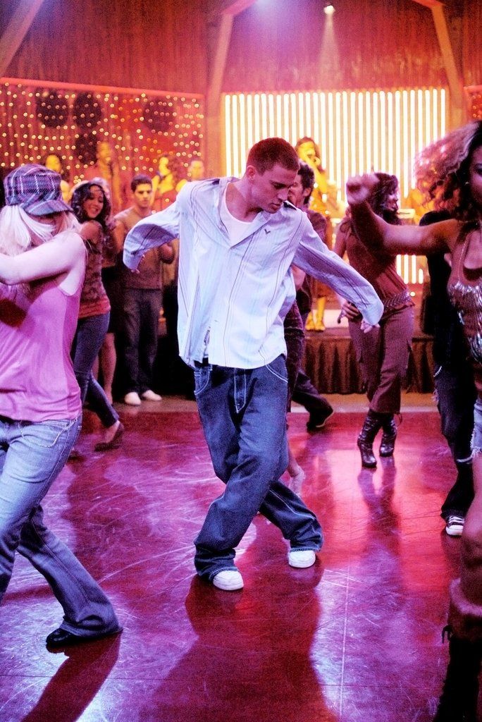 a group of people dancing on a dance floor