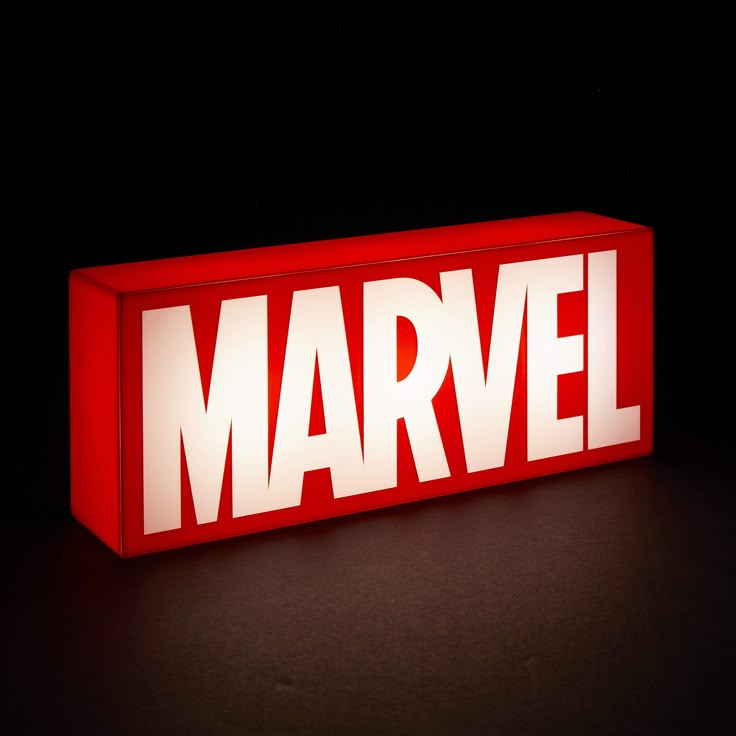 the word marvel is lit up in red and white on a black background with light