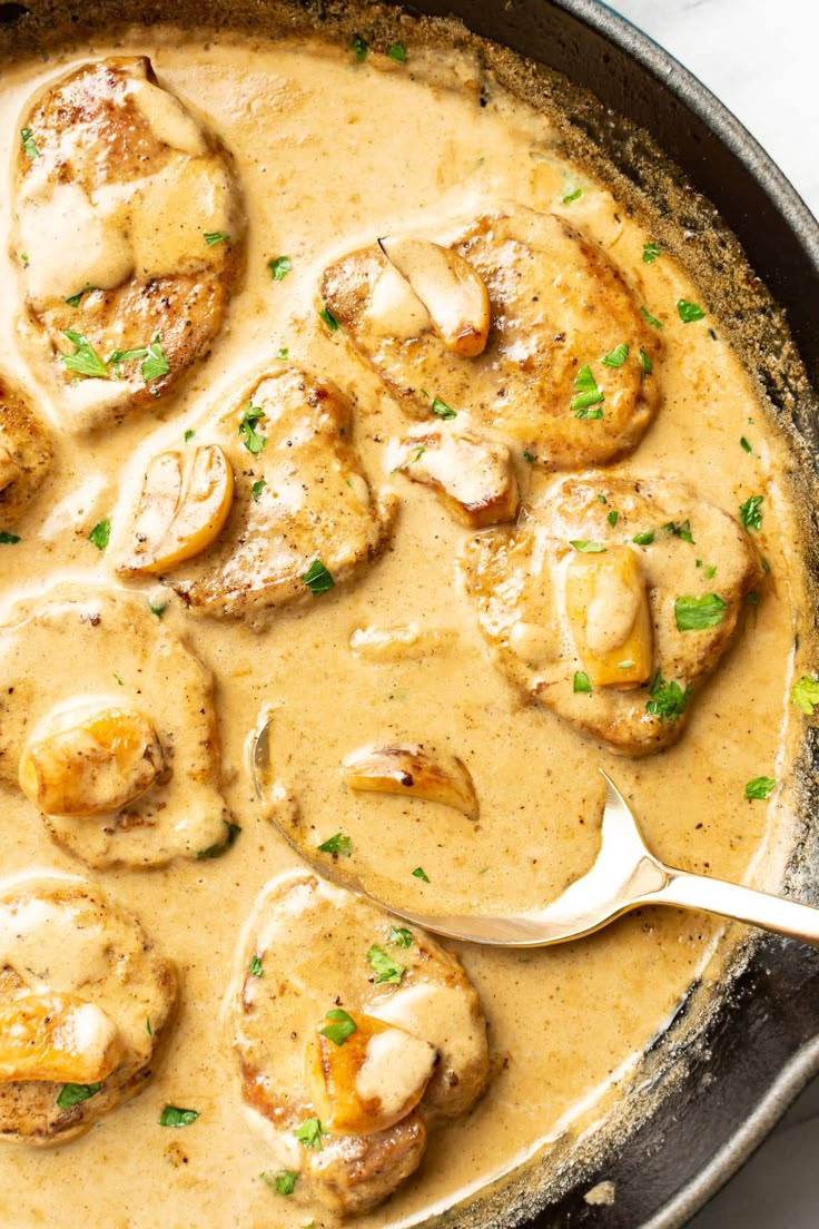 a skillet filled with meat covered in gravy