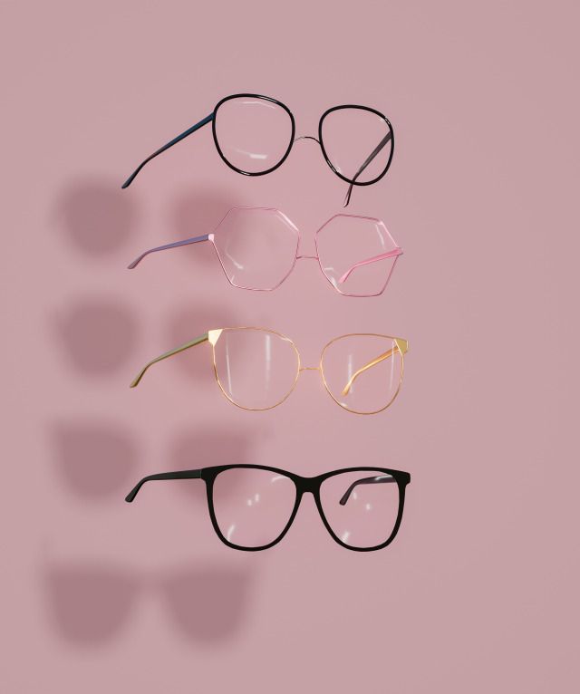 five pairs of glasses on a pink background