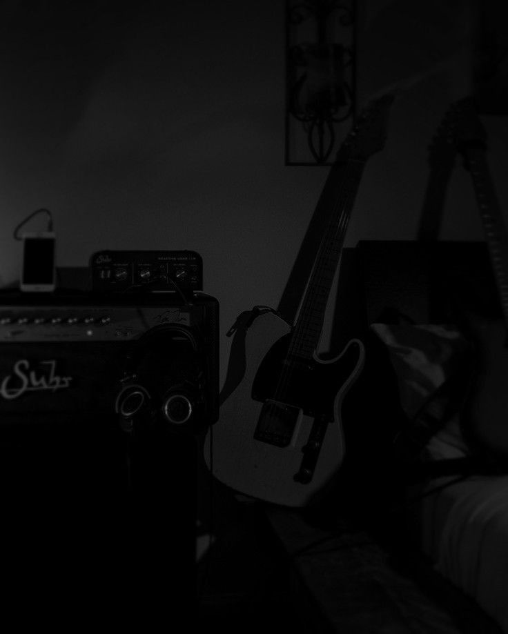 a guitar and amp in a dark room