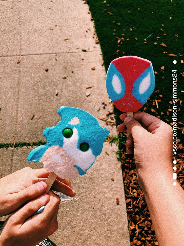 two people holding up some kind of toy