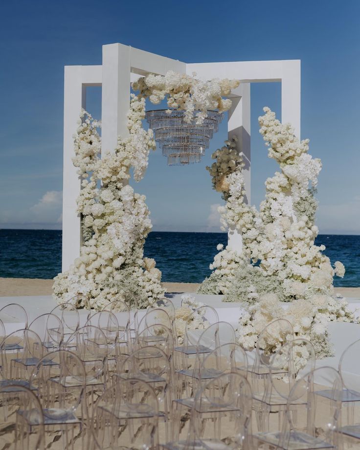 an outdoor wedding setup with chairs and flowers