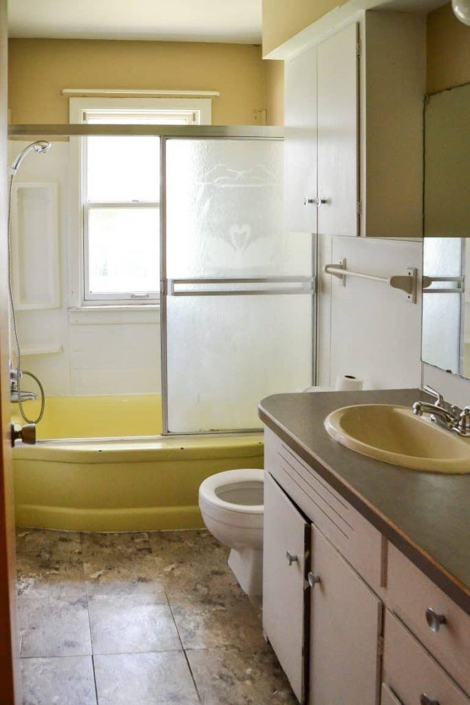 a bathroom with a sink, toilet and bathtub next to a shower stall in the corner