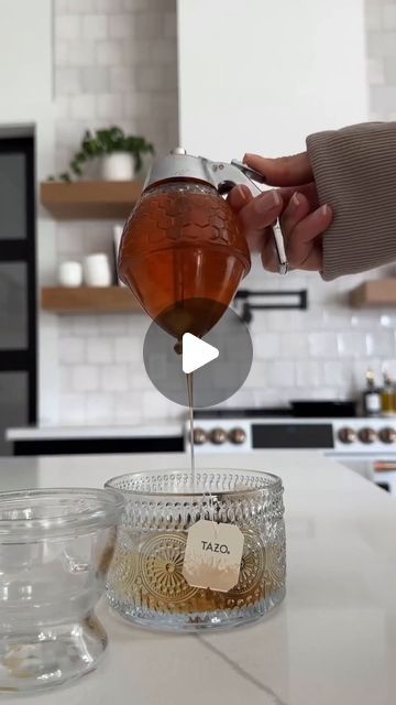 a person pours tea into a glass bowl