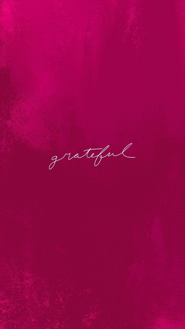 a pink background with the word grateful written in cursive writing on top of it