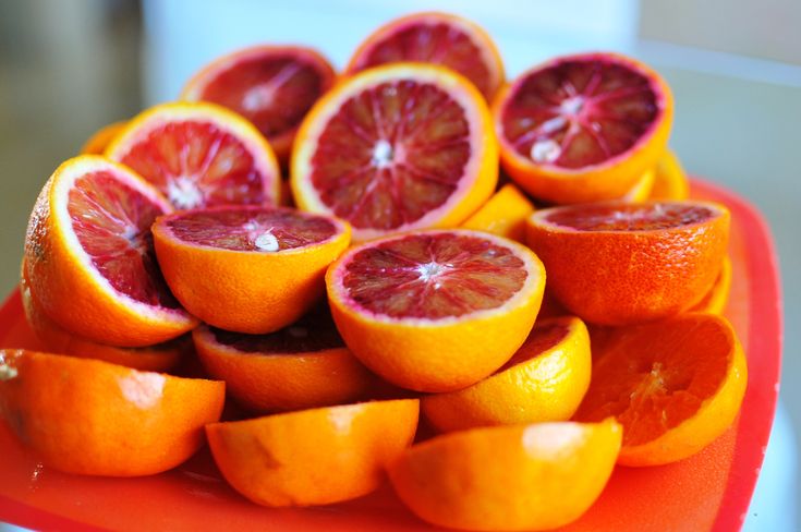 oranges cut in half on a red plate