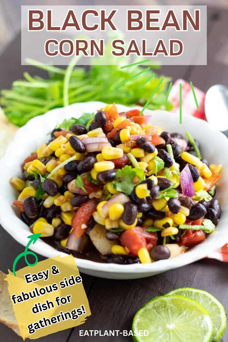 black bean corn salad in a white bowl with lime wedges and cilantro on the side