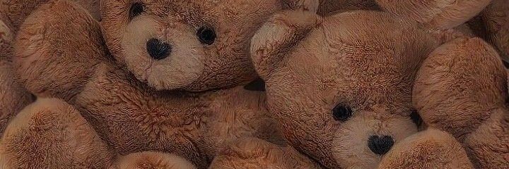 a pile of brown teddy bears sitting next to each other