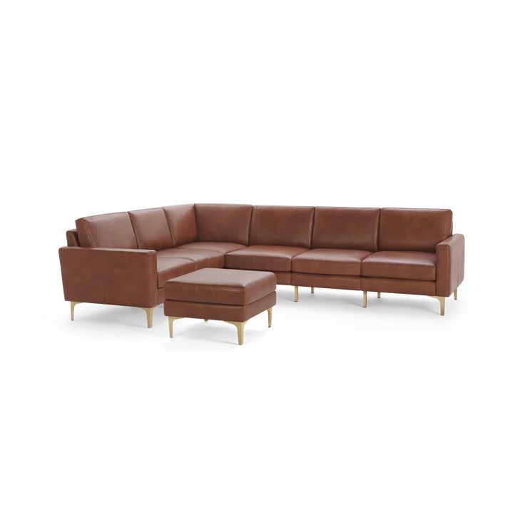 a brown leather sectional sofa with ottoman and footstool in front of a white background