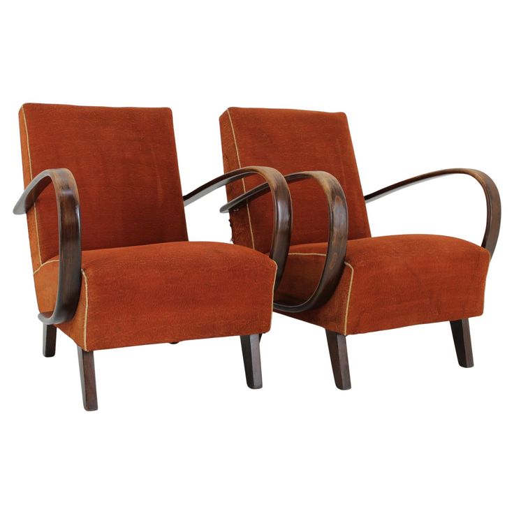 pair of art deco chairs with curved arms in orange velvet upholstered to the back