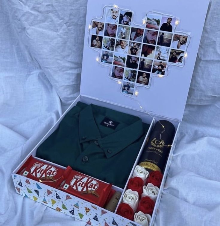 an open coca cola box on a bed with pictures and other items in it,