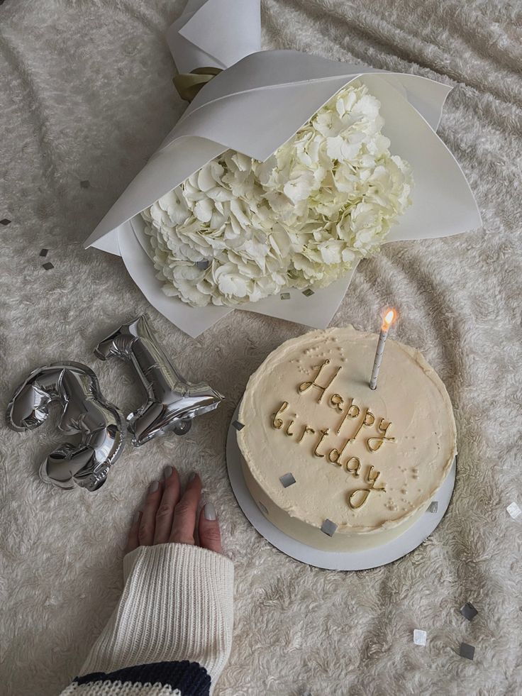 a birthday cake with the words happy birthday on it next to a pair of scissors