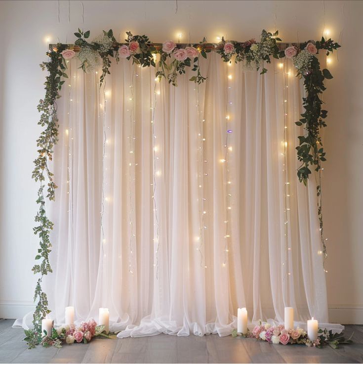 the wedding backdrop is decorated with flowers and candles