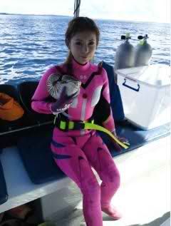 a woman in a pink wet suit on a boat