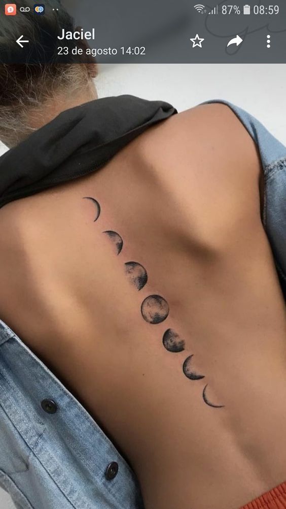 the back of a woman's neck with phases on it