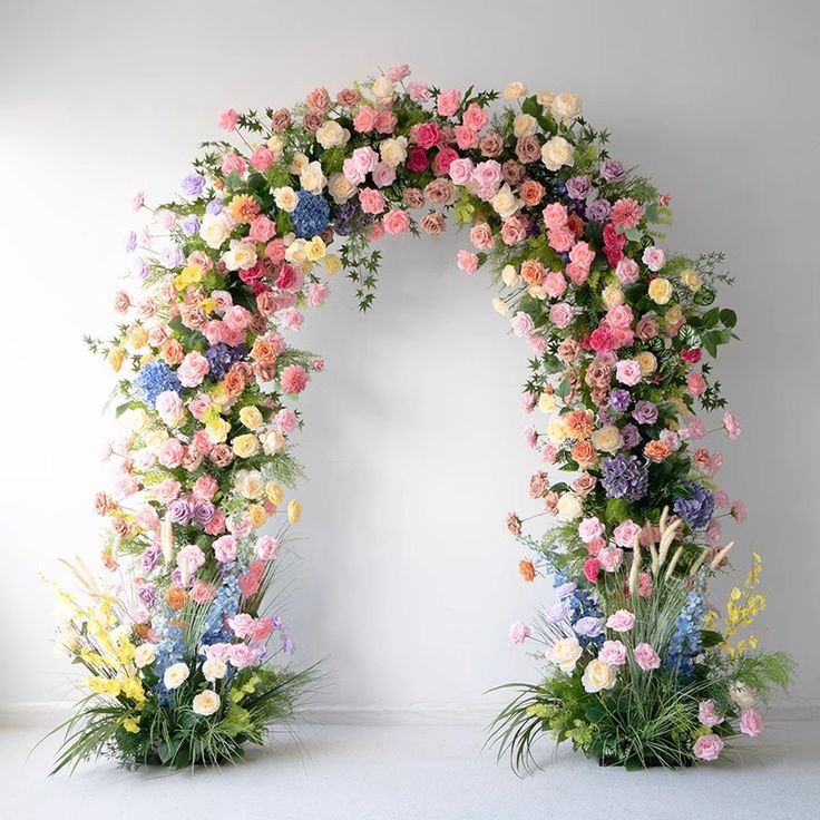 an arch made out of flowers and greenery