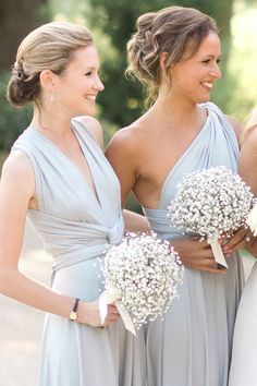 two bridesmaids holding bouquets of baby's breath