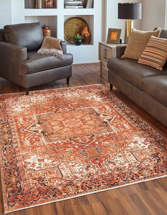 a living room with two brown couches and a rug on the floor in front of some bookshelves