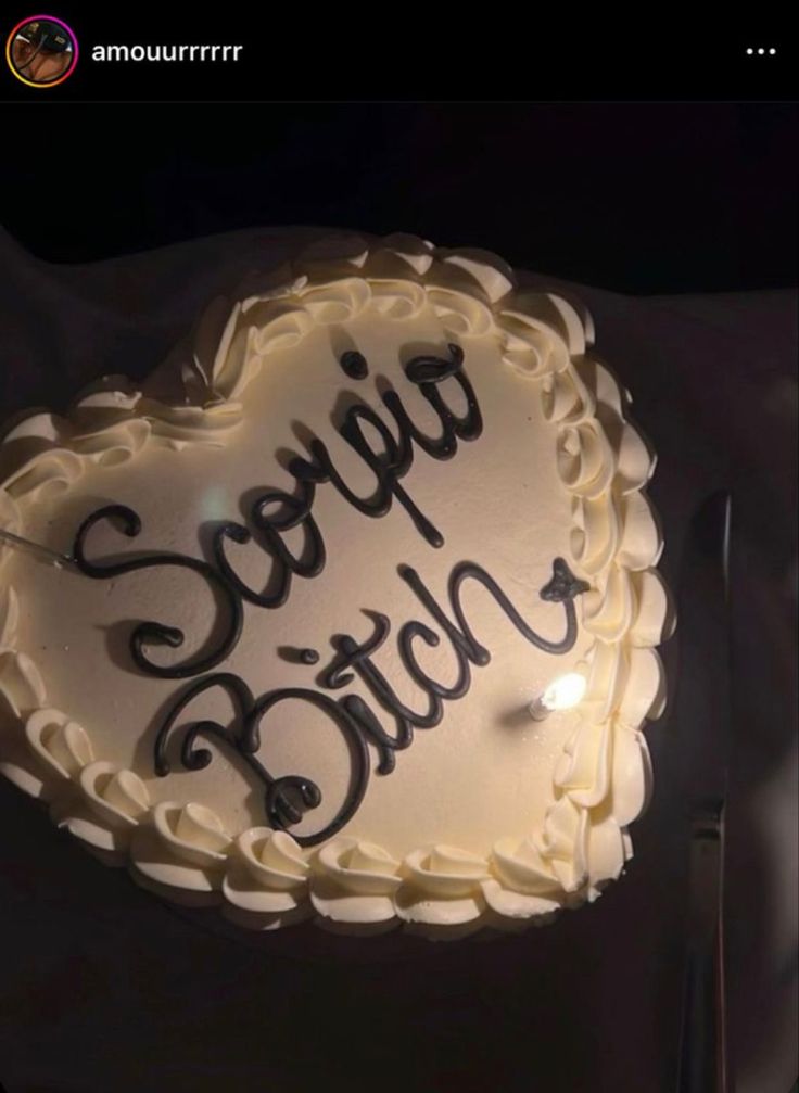 a heart shaped cake with writing on it