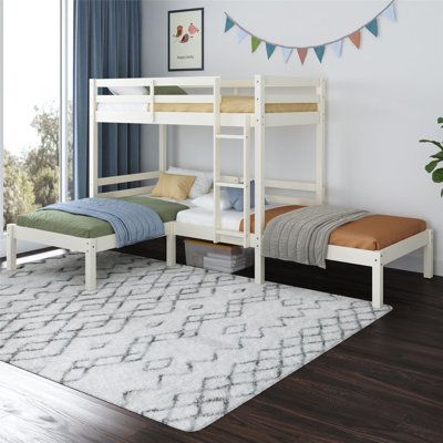 a white bunk bed sitting on top of a wooden floor next to a rug and window