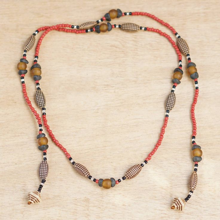 Crafted by the expert hands of Ghanaian artisans, this beaded necklace is the perfect complement to a bohemian and eco-friendly style. Designed by Rita Addo Zakour, the accessory is made from recycled glass and plastic beads, all in a palette of intense hues. Artisan Long Adjustable Beaded Necklaces, Artisan Adjustable Long Beaded Necklace, Natural Bohemian Beads For Gift, Bohemian Natural Beads For Gift, Bohemian Natural Beads As A Gift, Bohemian Natural Beads As Gift, Adjustable Bohemian Beaded Necklace In Natural Color, Bohemian Beaded Necklace With Adjustable Fit, Bohemian Natural Beaded Necklaces