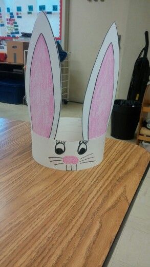 a paper bunny head sitting on top of a wooden table