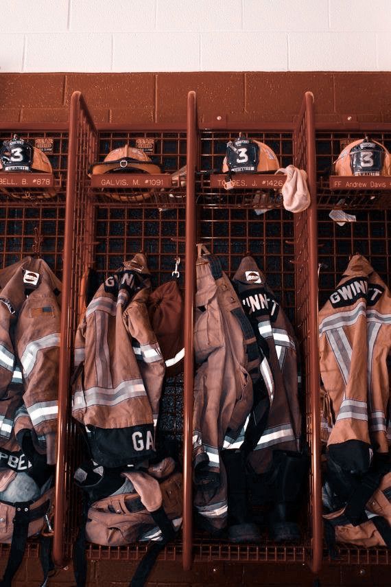 the fireman's jackets are lined up on racks