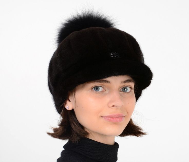 a woman wearing a black hat with fur on it