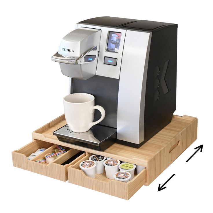 a coffee machine with two cups in it and an extra tray for the espresso