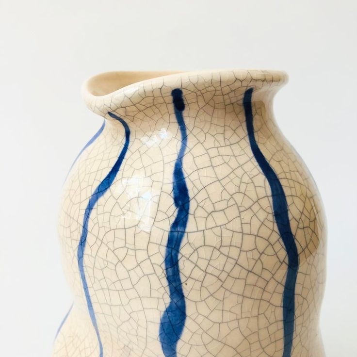 a blue and white vase sitting on top of a table