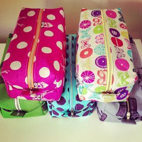 three colorful bags sitting on top of a white counter