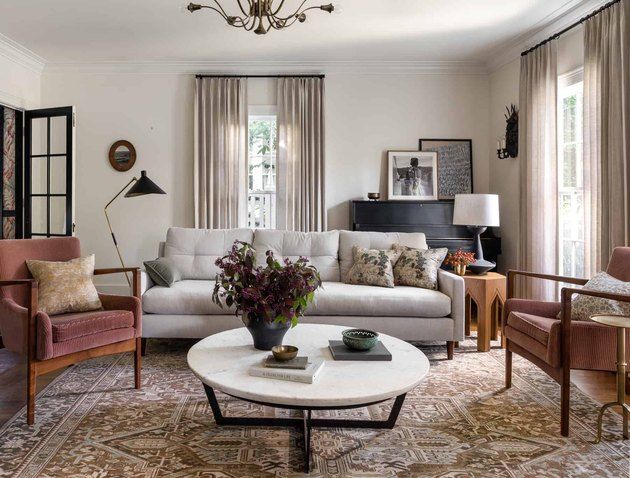 a living room filled with furniture and a chandelier