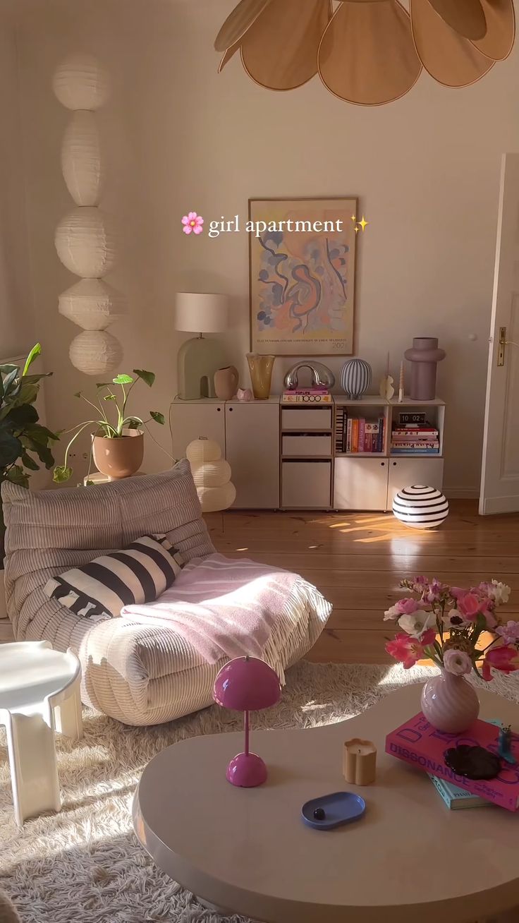 a living room filled with furniture and flowers on the coffee table in front of it