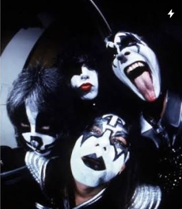 the kiss band members with their faces painted black and white