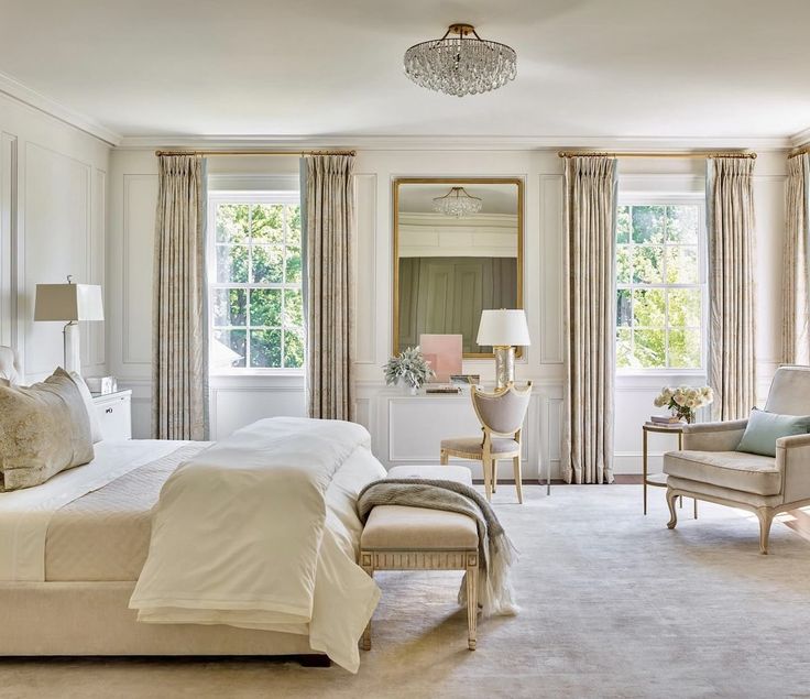 a bedroom with white walls and beige curtains