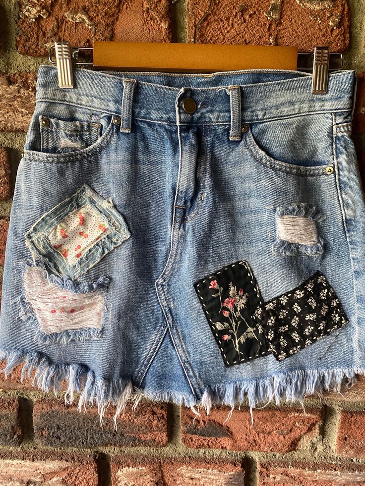 a denim skirt with patches and flowers on it