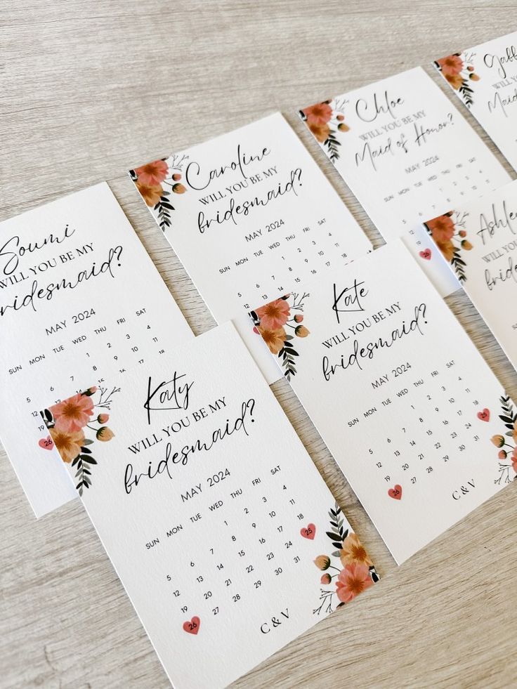 wedding seating cards with watercolor flowers and hearts on them for guests to sign in