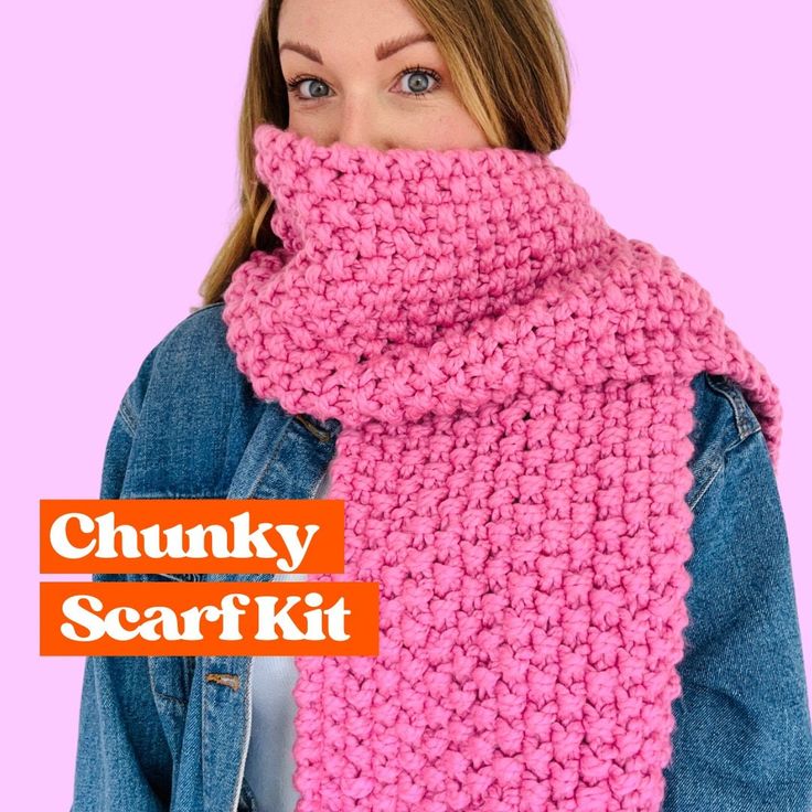 a woman wearing a pink knitted scarf with the words chunk scarf kit on it