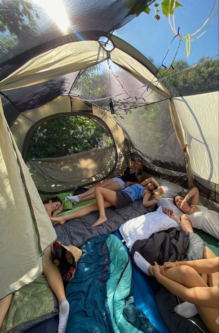 some people are sleeping in a tent with the sun shining on them and there is no image here to provide a caption for