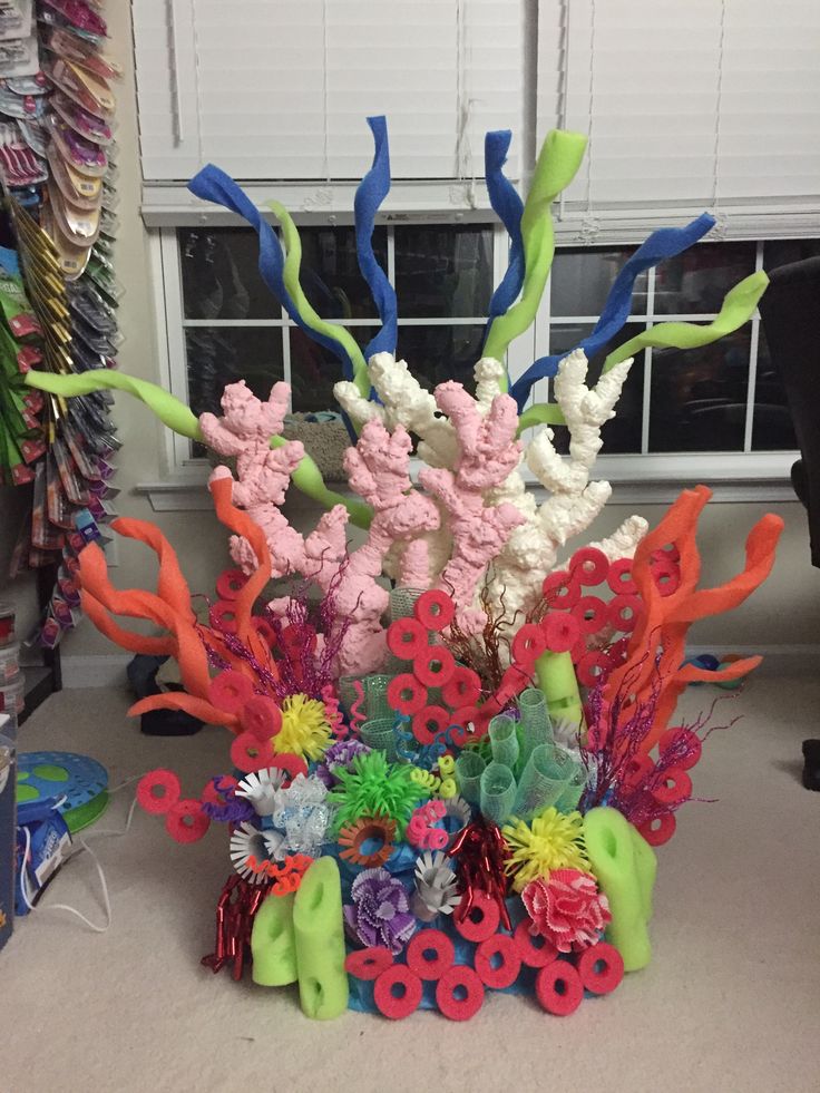 an arrangement of colorful plastic flowers and plants