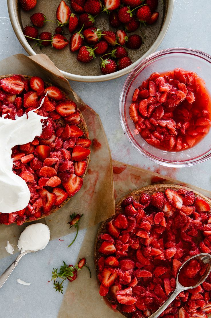 two pies with strawberries and whipped cream on top