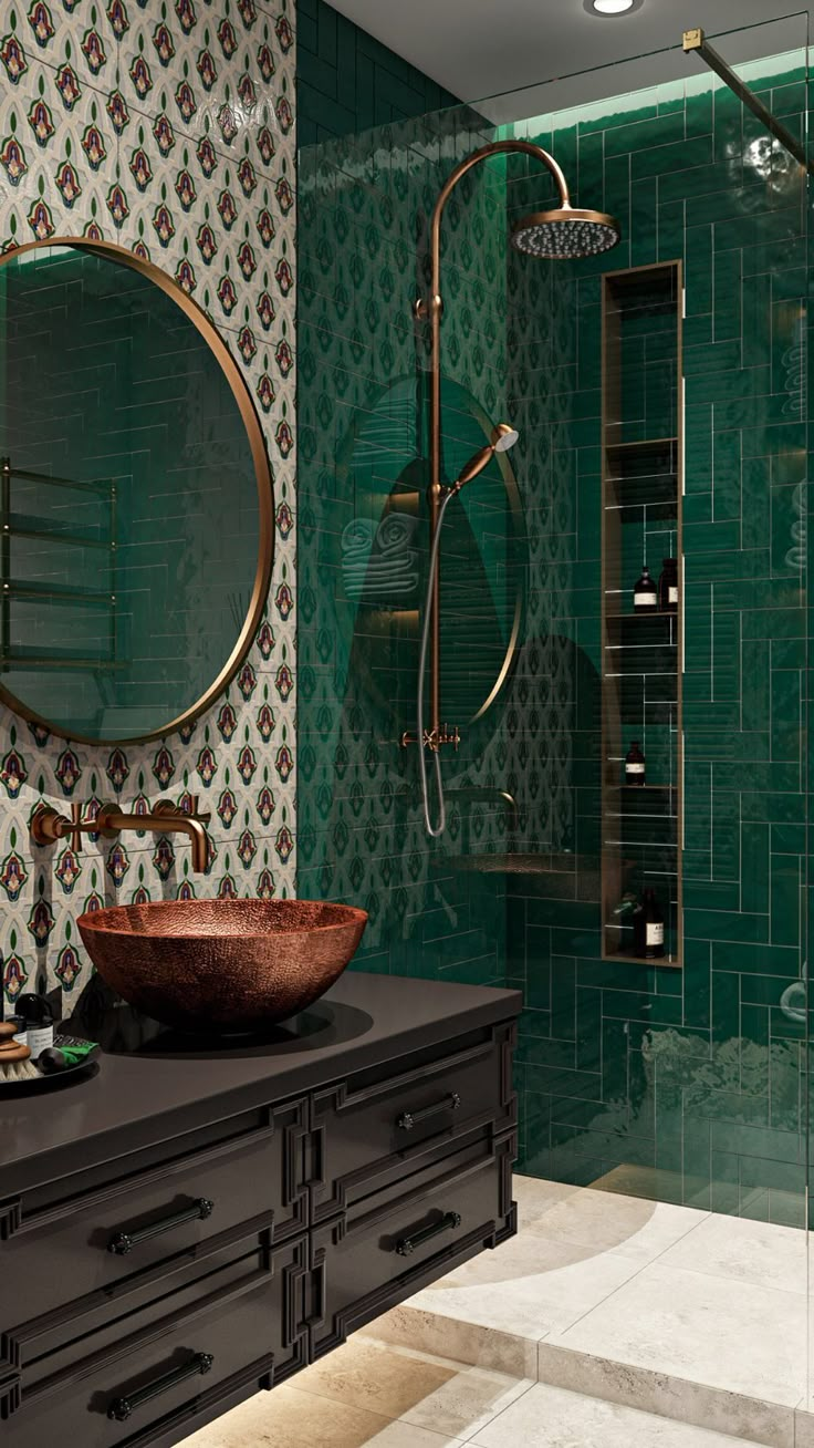 a bathroom with green tiled walls and a round mirror on the wall above the sink