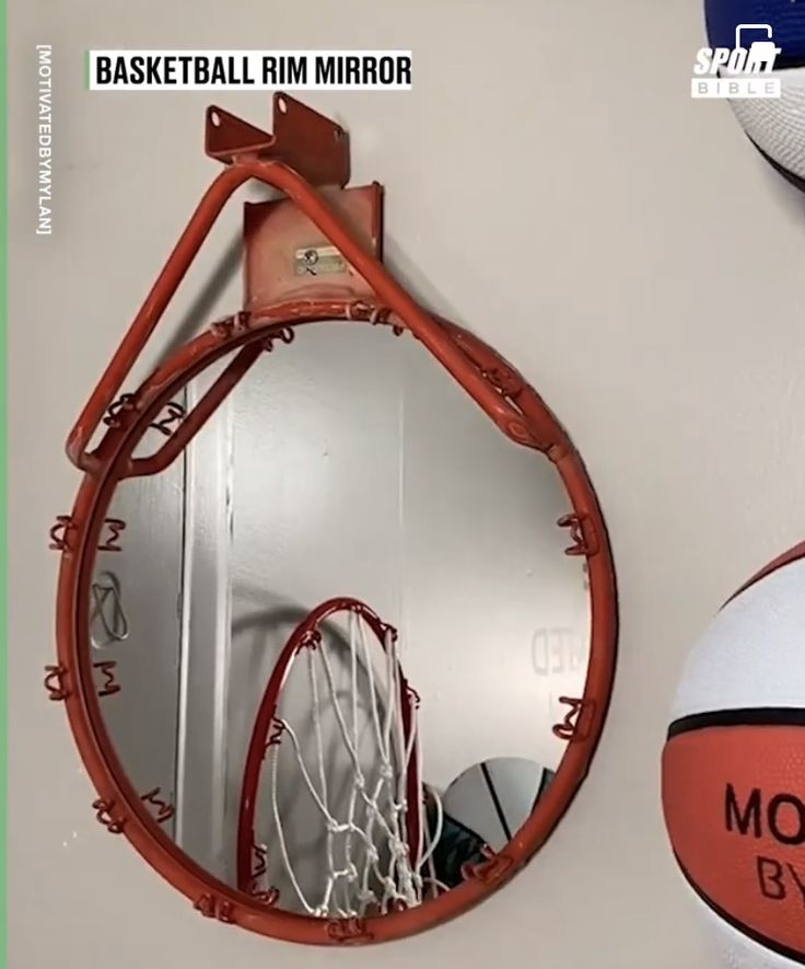 a basketball is hanging on the wall next to a mirror with an orange net attached