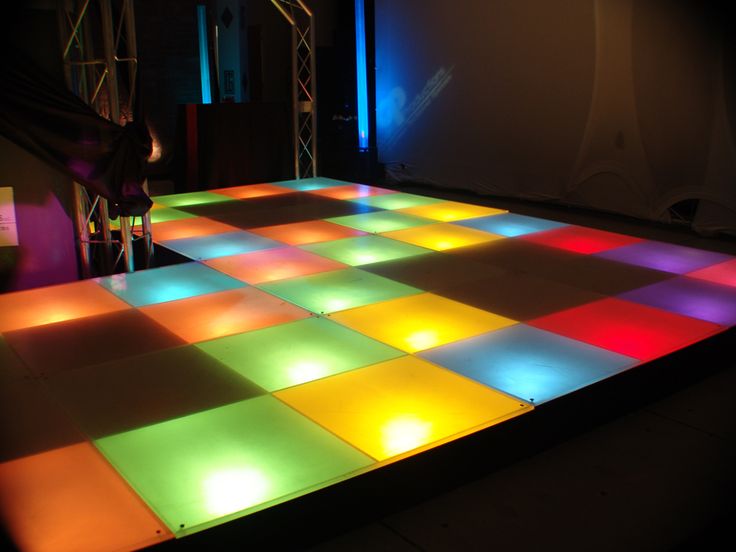 an illuminated dance floor with colored squares on it