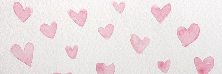 pink hearts painted on white paper with watercolor