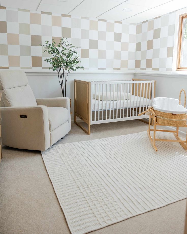 a baby's room with a crib, chair and rug