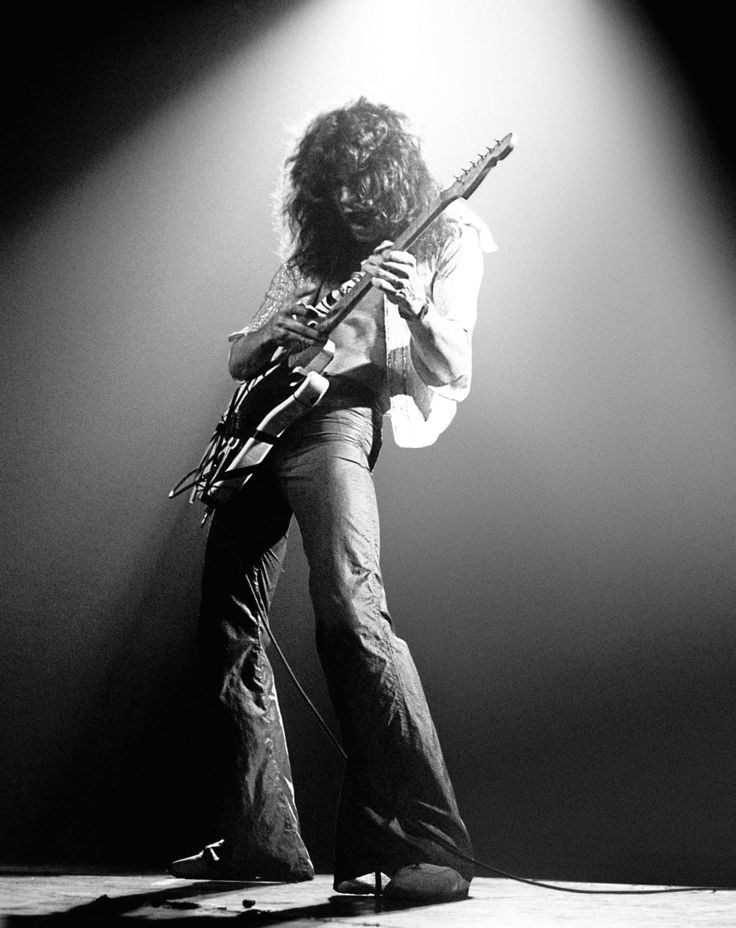 an image of a man playing guitar on stage