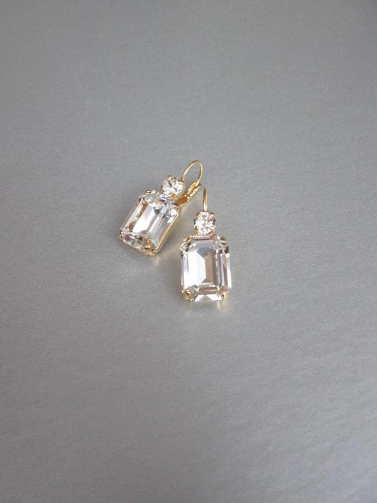 "These beautiful elegant earrings are made with fancy emerald cut and round Swarovski crystals. Available in gold, rose gold and silver finish. Matching necklaces an the bracelet are also available and they are shown in the last two photos. - 1 3/8\" long from the top of the ear wire to the bottom of the earring and 1/2\" wide - Leverback - For the matching bracelet please take a look here: https://www.etsy.com/listing/754440549/swarovski-crystal-bridal-bracelet-gold?ref=shop_home_active_19& Bridal Gold Earrings, Wedding Drop Earrings, Inexpensive Jewelry, Earrings Emerald, Gold Bridal Earrings, Wedding Earrings Drop, Matching Jewelry, Jewelry Lookbook, Earrings In Gold